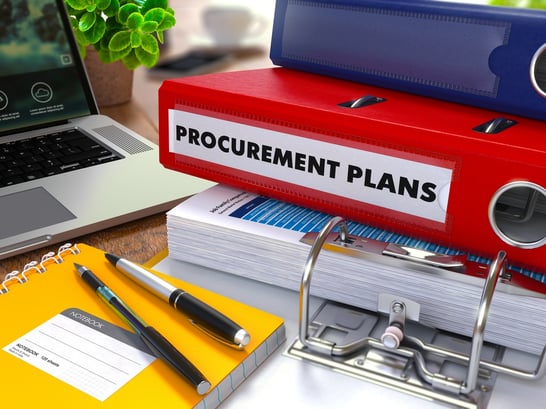 Red Ring Binder with Inscription Procurement Plans on Background of Working Table with Office Supplies, Laptop, Reports. Toned Illustration. Business Concept on Blurred Background..jpeg