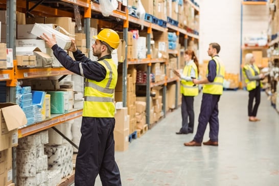 Warehouse worker taking package in the shelf in a large warehouse in a large warehouse.jpeg