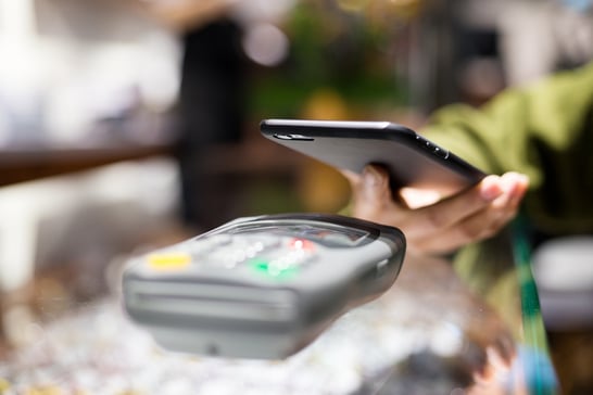 Woman paying with smartphone by NFC.jpeg