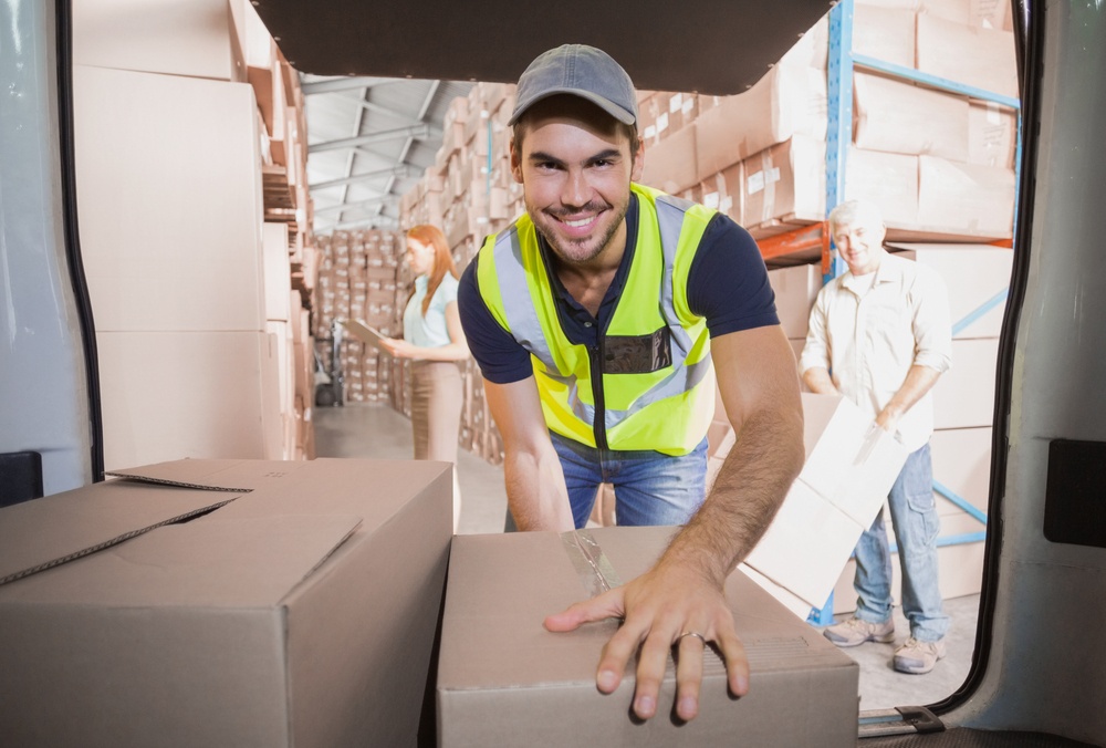 Delivery driver loading his van with boxes outside the warehouse-1.jpeg