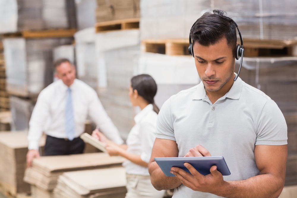 Female manager using digital tablet in warehouse.jpeg